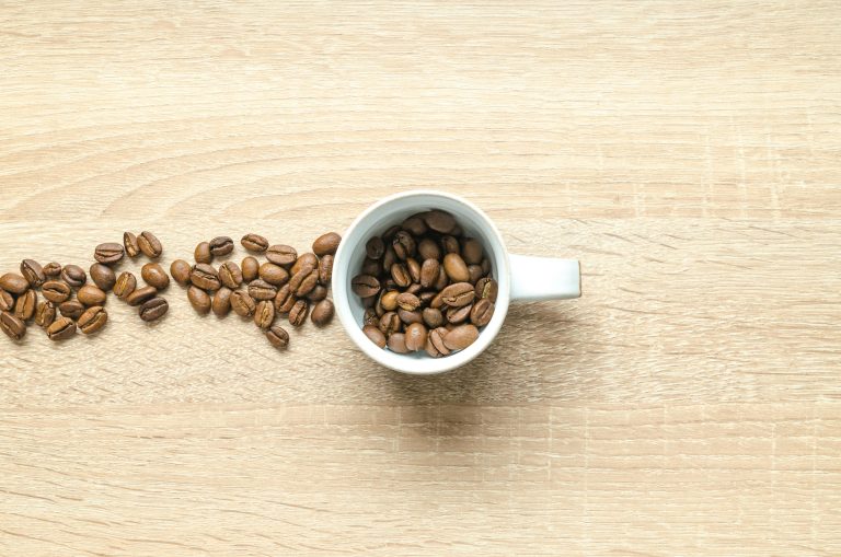 best light roast coffee beans in a cup and on the table